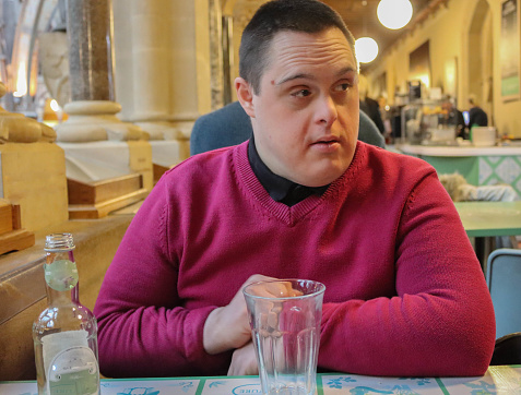 Scott, a young man with Down's syndrome in a cafe in Oxford, England