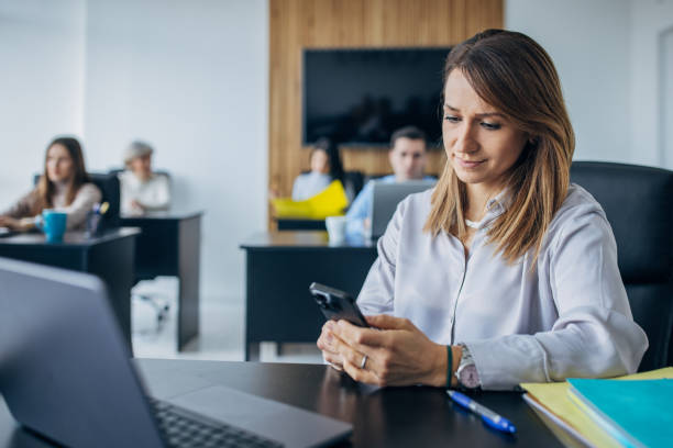 istock Business woman using mobile phone in the office 1463823149