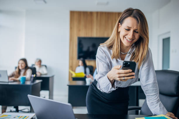 istock Business woman using mobile phone in the office 1463823355