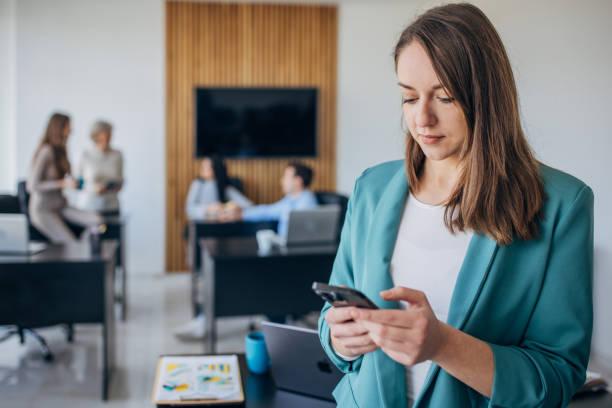 istock Business woman using mobile phone in the office 1463823454