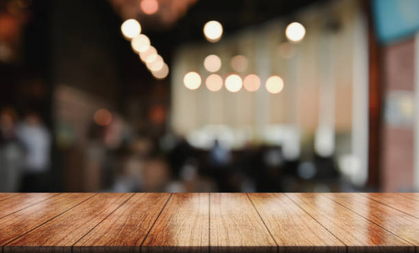 istock Empty wooden table top with lights bokeh on blur restaurant background. 1463823507