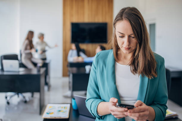 istock Business woman using mobile phone in the office 1463823528