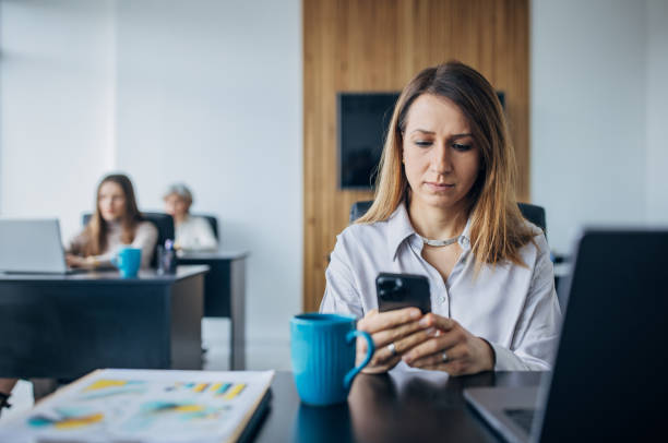 istock Business woman using mobile phone in the office 1463823688