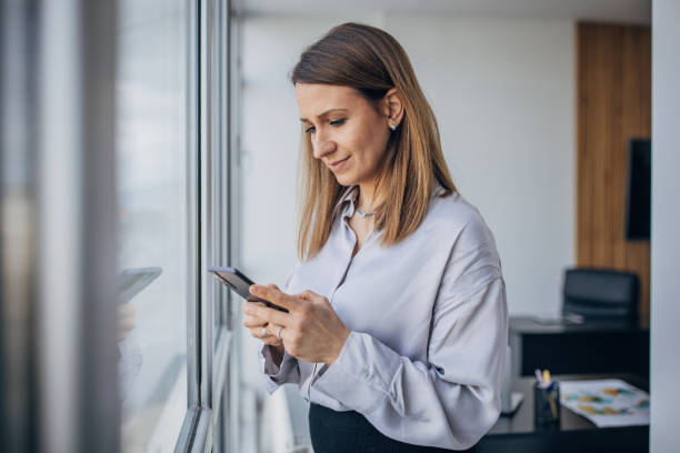 istock Business woman using mobile phone in the office 1463824166