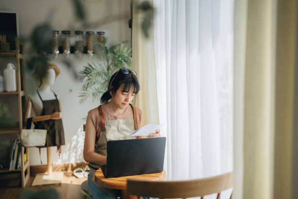 istock Happy female manager checking finances of her store. 1463825105