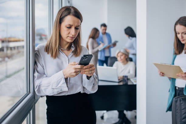 istock Business woman using mobile phone in the office 1463825246
