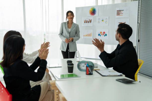 istock Businesswoman proficiently present work project receive celebrations from team . Corporate business team collaboration concept . 1463825741