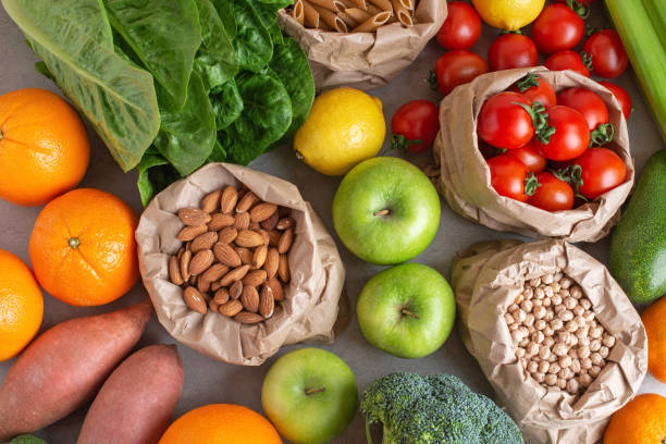 istock zero waste packaging. Different vegetables and fruits in paper bags on the table 1463826468