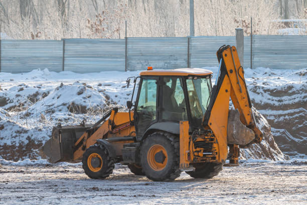 istock Orange wheeled tractor excavator at construction site in winter 1463826471