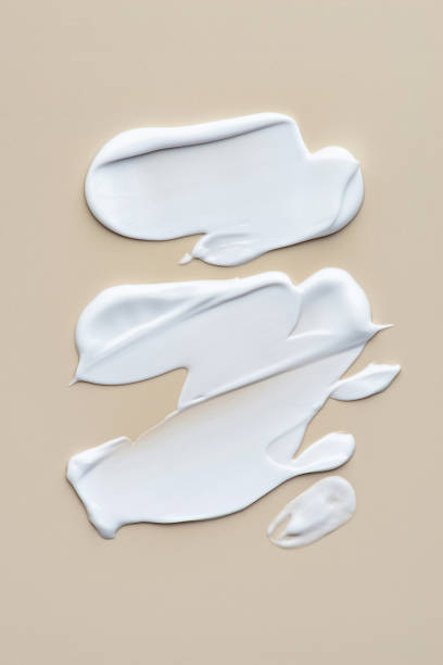 istock Smears of white cream on a beige background, cream texture 1463826606