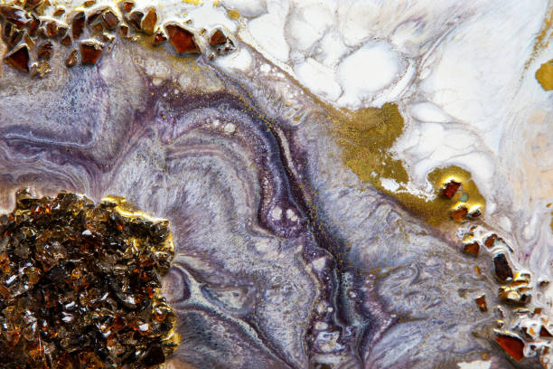 Background from handmade epoxy resin product close-up: wall panel with gold inserts.
