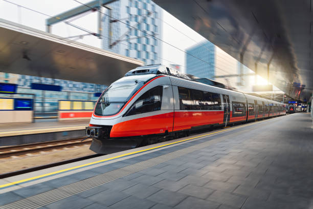 istock Red high speed train in motion on the railway station at sunset. Fast modern intercity train and blurred background. Railway platform. Railroad in Austria. Commercial and passenger transportation 1463827470