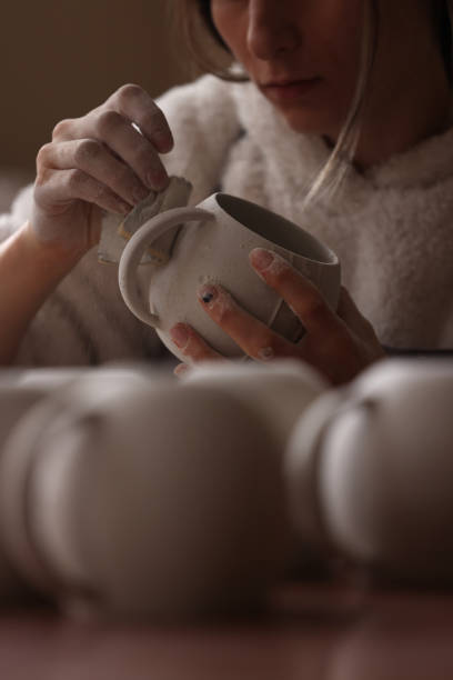 Ceramic artist makes coffee cups stock photo