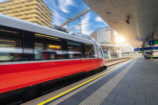 istock Red high speed train in motion on the railway station at sunset. Fast modern intercity train and blurred background. Railway platform. Railroad in Austria. Commercial and passenger transportation 1463827529