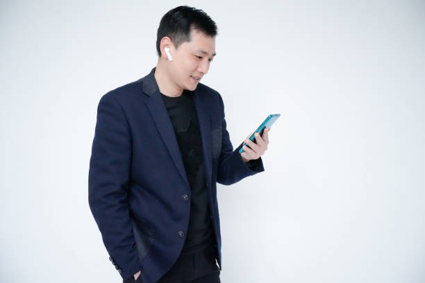istock Portrait of businessman, white collar, office worker wearing wireless headset using mobile phone for video call 1463827602