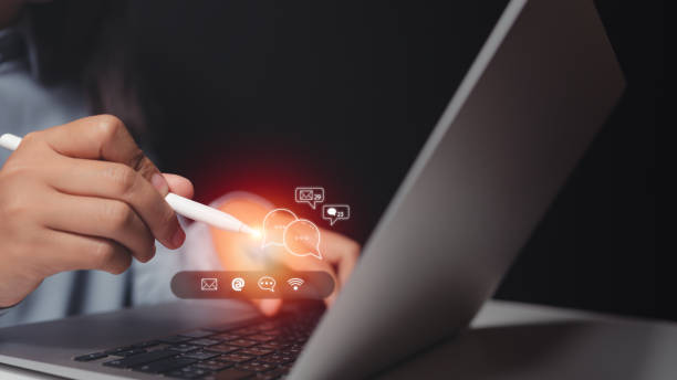istock chat and recieve email, customer support hotline Contact us people connection. Businessman using computer keyboard with the email, call phone, address, Chat message icons. 1463828257