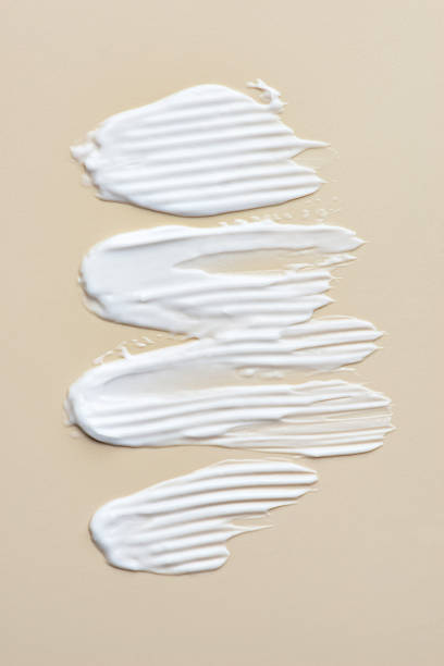 istock Smears of white cream on a beige background, cream texture 1463828506