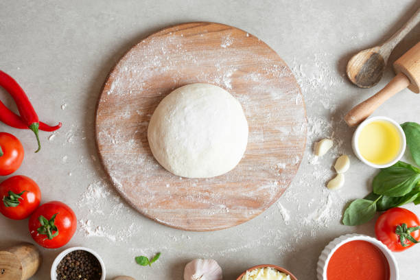 istock The process of making margarita pizza. Male hands, top view. Tomato paste with cheese. 1463828566