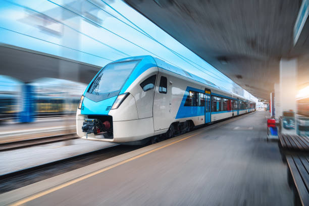 istock Blue high speed train in motion on the railway station at sunset. Fast modern intercity train and blurred background. Railway platform. Railroad in Slovenia. Commercial and passenger transportation 1463829086