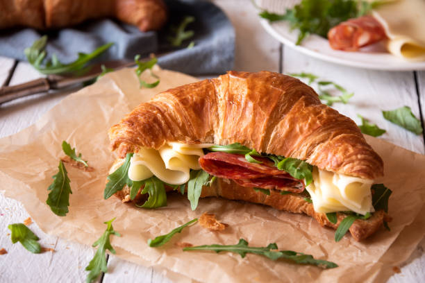 istock Delicious croissant sandwich with cheese and arugula 1463829425