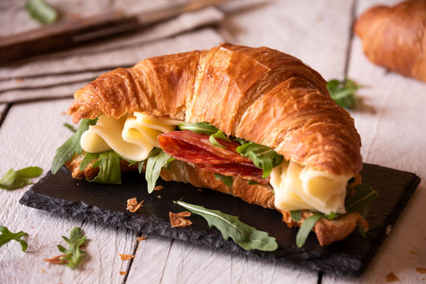 istock Delicious croissant sandwich with cheese and arugula 1463829995