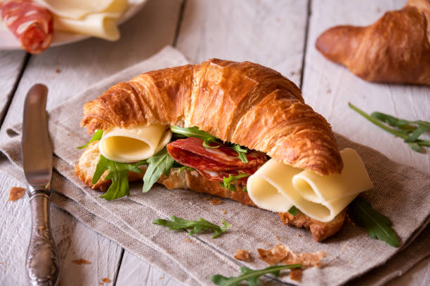 istock Delicious croissant sandwich with cheese and arugula 1463830137
