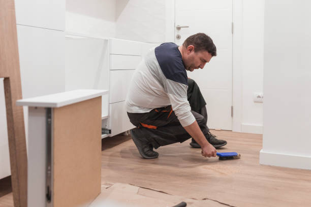 istock Handyman cleaning floor after working on a new kitchen installment 1463830544
