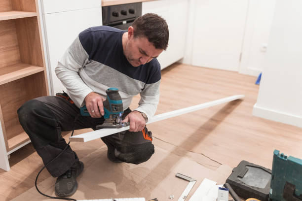 istock Confident carpenter working with a jigsaw, interior of a domestic kitchen 1463830644