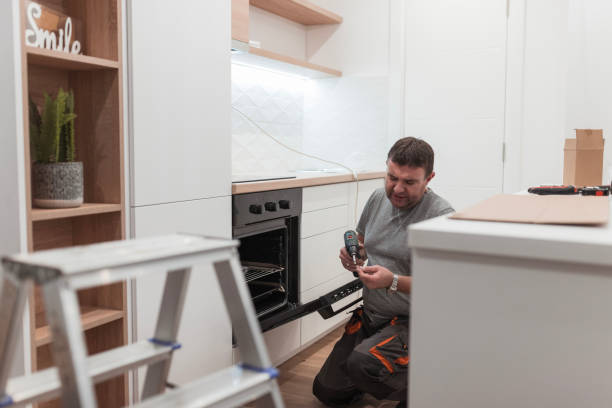 istock Man frowning when fixing a stove in a kitchen 1463830668