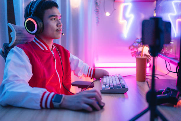 istock A disabled gamer is streaming matches and chatting with viewers on his stream. 1463832380
