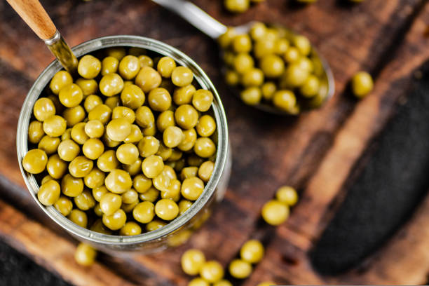 istock Canned green peas on a cutting board. 1463833310