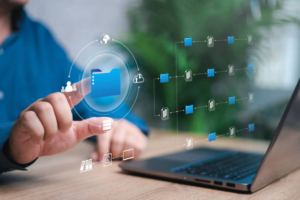 istock Document management and business development in virtual screens concept, Human pointing on smart folder document and data management for efficient archiving and company data, with laptop on wood table 1463833562