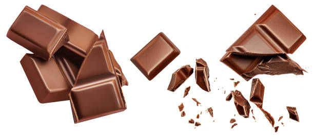 istock Dark chocolate chunks isolated on white background. Collection. Flying Chocolate pieces, shavings and cocoa crumbs Top view. Flat lay. Pattern 1463833966