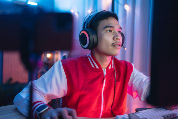 istock A disabled gamer is streaming matches and chatting with viewers on his stream. 1463834170