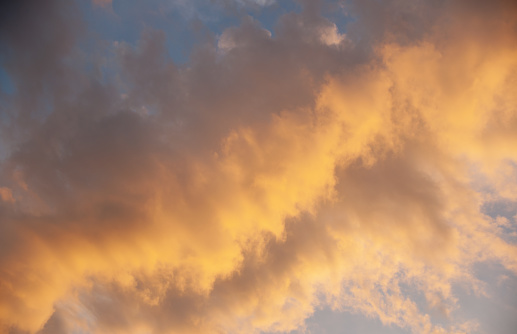 Looking up at colorful orange clouds at dusk