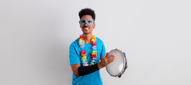 Carnival Brazilian Outfit. Black Man With Carnival Costume Holding a Tambourine Isolated on White.