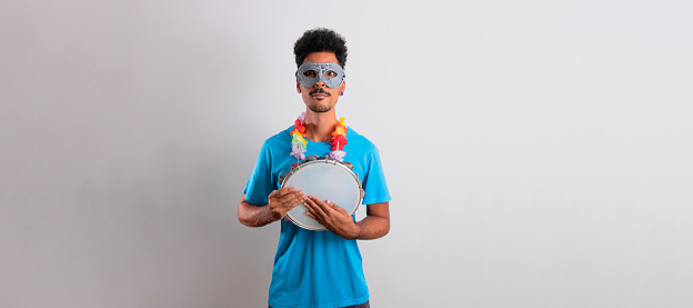Carnival Brazilian Outfit. Black Man With Carnival Costume Holding a Tambourine Isolated on White.