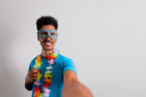 Carnival Brazilian Outfit. Black Man With Carnival Costume Taking Selfie Isolated on White.