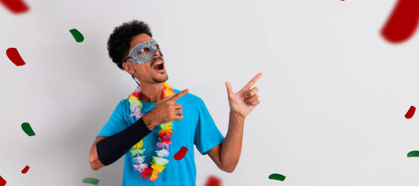 istock Black Man With Carnival Costume Pointing Isolated on White. 1463835718