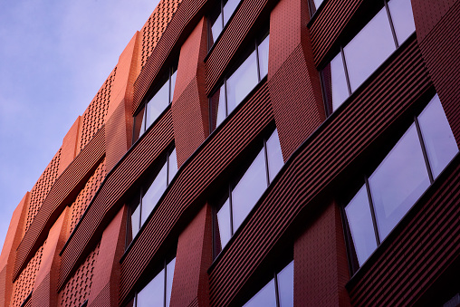 A newly built brick building with a seamless woven brickwork pattern