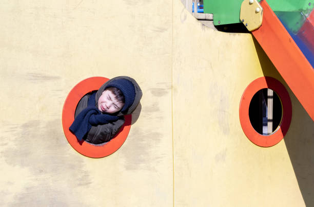 kid having fun at playground on slide swing ship shape colorful construction