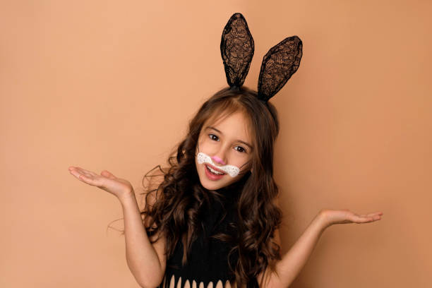 istock Comic girl dressed as a rabbit with a painted face spreads hands in surprise 1463840308