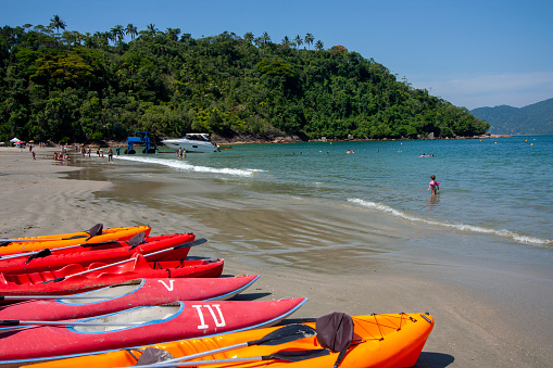 Orange and red boats for rent at Ubatuba's beach. Brazilian summer activities