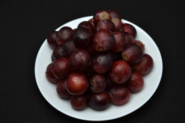 Red fresh grapes. Grapes on a plate. Large grapes.