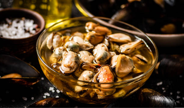 istock Pickled mussels in a glass bowl with spices. 1463841877