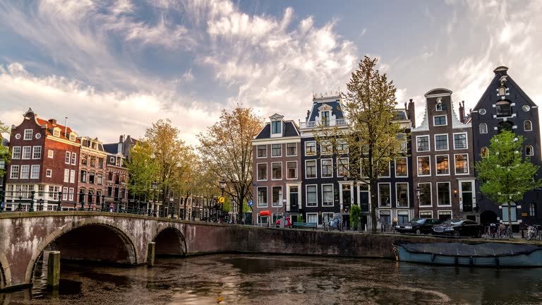 Amsterdam Netherlands time lapse 4K, city skyline sunset timelapse at canal waterfront