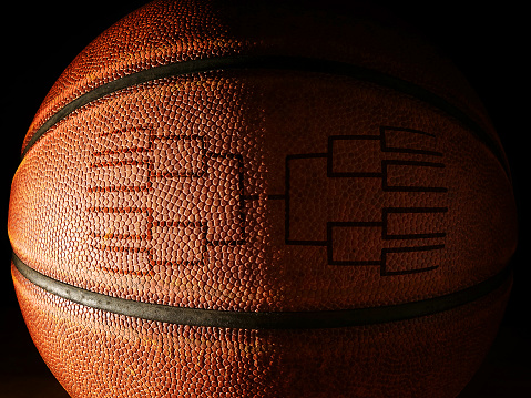 Closeup of a basketball with a tournament bracket design