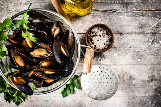istock Delicious boiled mussels in a colander on the table. 1463845747