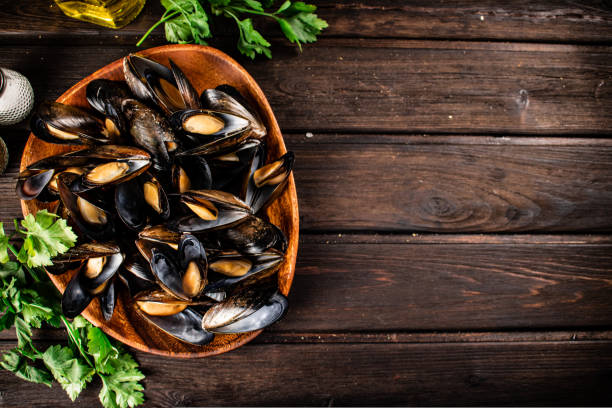 istock Boiled mussels in a plate with parsley. 1463846186