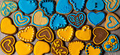 istock Yellow and blue heart-shaped decorated cookies. Background. Pattern 1463849818